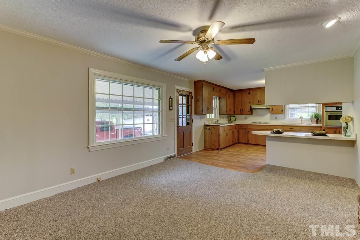 716 Sheriff Johnson Road Coats, NC 27521 - Photo 9 of 25 a open kitchen with stainless steel appliances granite countertop a sink and cabinets