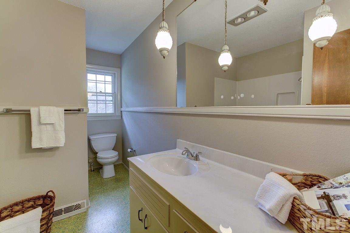 716 Sheriff Johnson Road Coats, NC 27521 - Photo 10 of 25 a bathroom with a sink a toilet and mirror