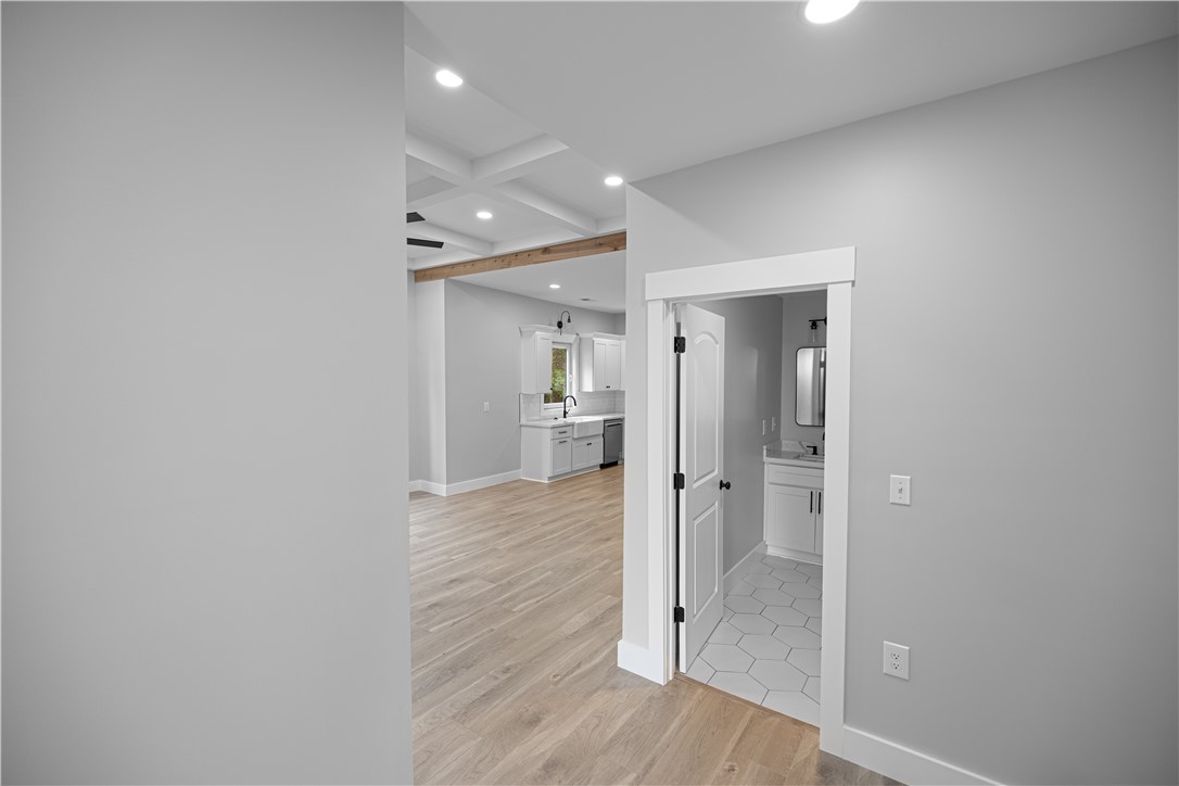 2817 Broadway Lake Road Anderson, SC 29621 - Photo 23 of 41 Clean lines and light wood flooring define this open-concept interior, leading to a modern kitchen and adjacent bathroom.
