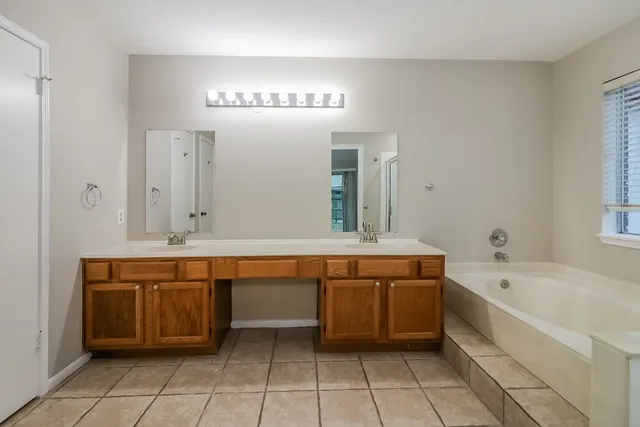 a bathroom with a sink a mirror and a bathtub