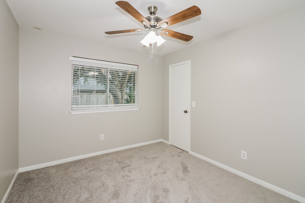 9423 Bayou Bluff Drive Spring, TX 77379 - Photo 14 of 16 an empty room with a window and a fan