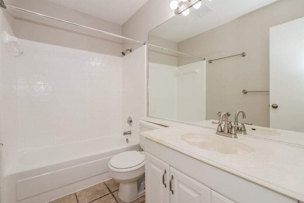 9423 Bayou Bluff Drive Spring, TX 77379 - Photo 15 of 16 a bathroom with a sink a toilet and shower