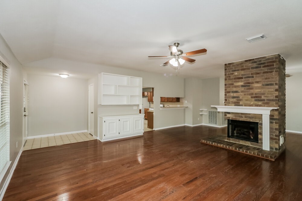9423 Bayou Bluff Drive Spring, TX 77379 - Photo 5 of 16 a living room with stainless steel appliances furniture a fireplace and wooden floor