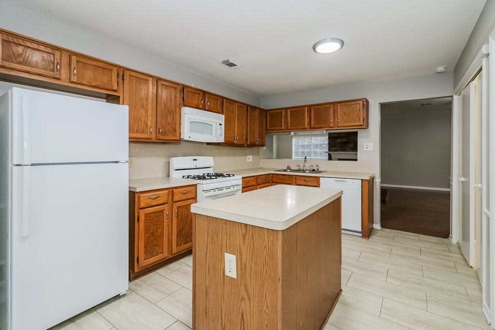 9423 Bayou Bluff Drive Spring, TX 77379 - Photo 7 of 16 a kitchen with stainless steel appliances granite countertop a refrigerator sink and cabinets