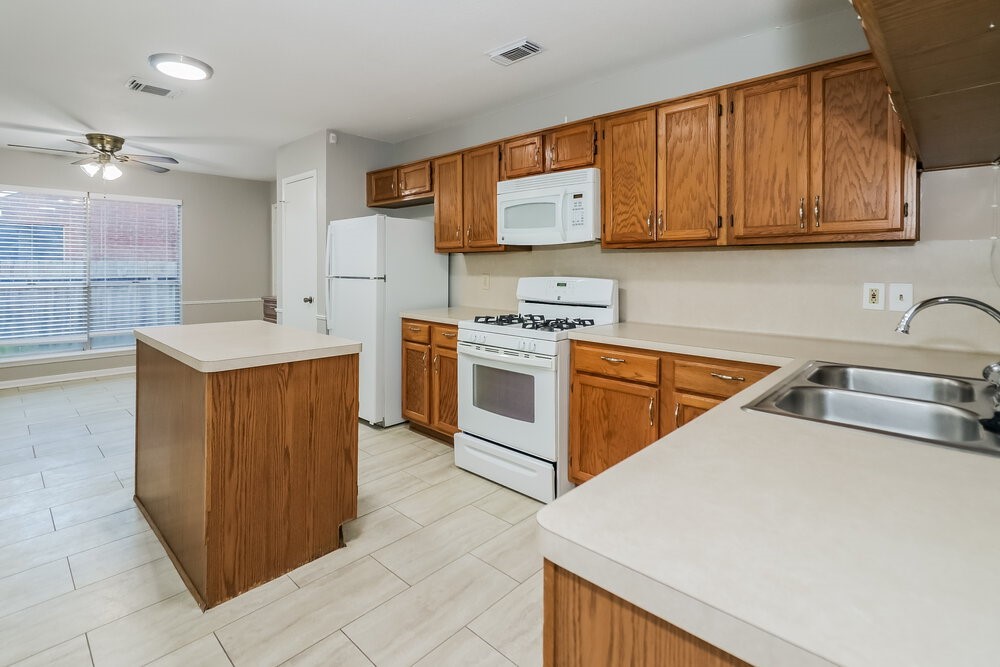 9423 Bayou Bluff Drive Spring, TX 77379 - Photo 8 of 16 a kitchen that has a sink and a stove in it