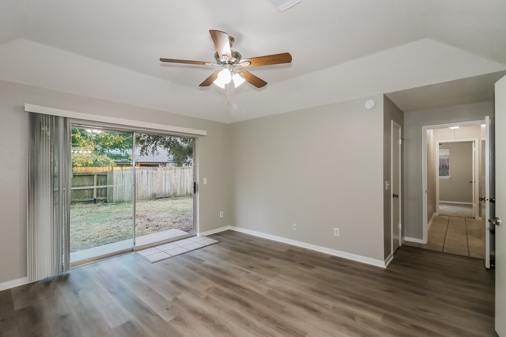 9423 Bayou Bluff Drive Spring, TX 77379 - Photo 9 of 16 a view of an empty room with wooden floor and a window