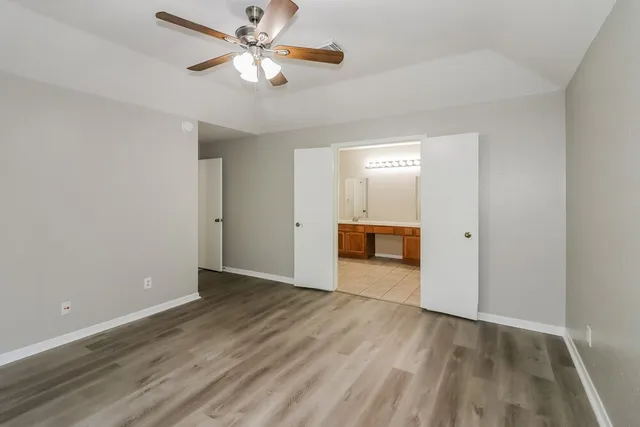 a spacious bathroom with a sink a mirror and a bathtub