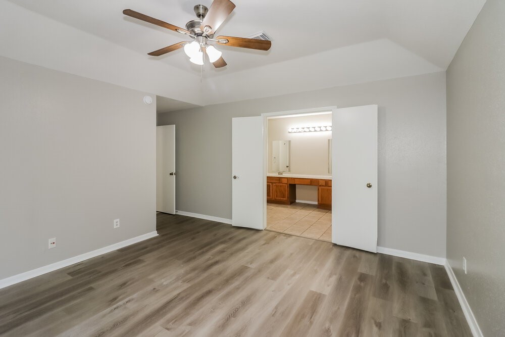9423 Bayou Bluff Drive Spring, TX 77379 - Photo 10 of 16 wooden floor in an empty room with a cabinet