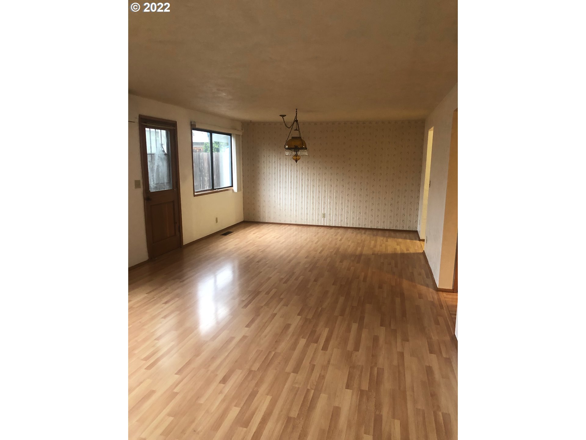 1190 South 44th Street Springfield, OR 97478 - Photo 5 of 9 a view of a room with wooden floor and a ceiling fan
