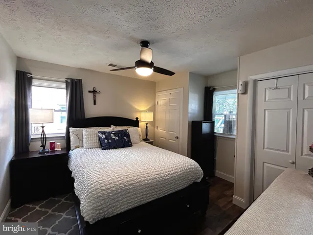 a bedroom with a bed and a mirror