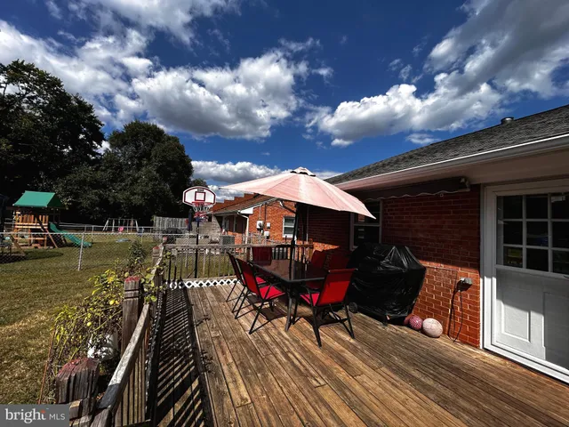 a patio with tables and chairs and a umbrella