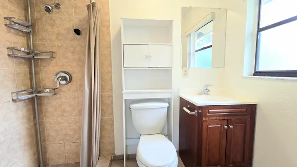 a bathroom with a sink toilet and shower