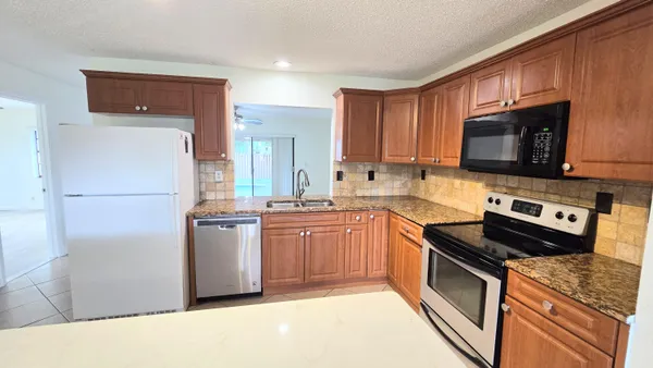 a kitchen with stainless steel appliances a stove sink and microwave