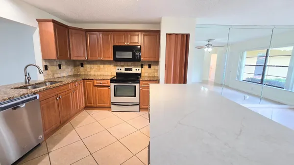 a view of kitchen with cabinets