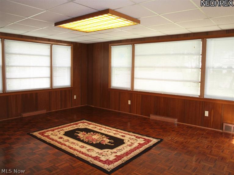 1577 Wood Road Cleveland, OH 44121 - Photo 7 of 25 12x14 Family Room with wood floor (not laminate) and plenty of windows to let natural light in and a door to the backyard and patio area