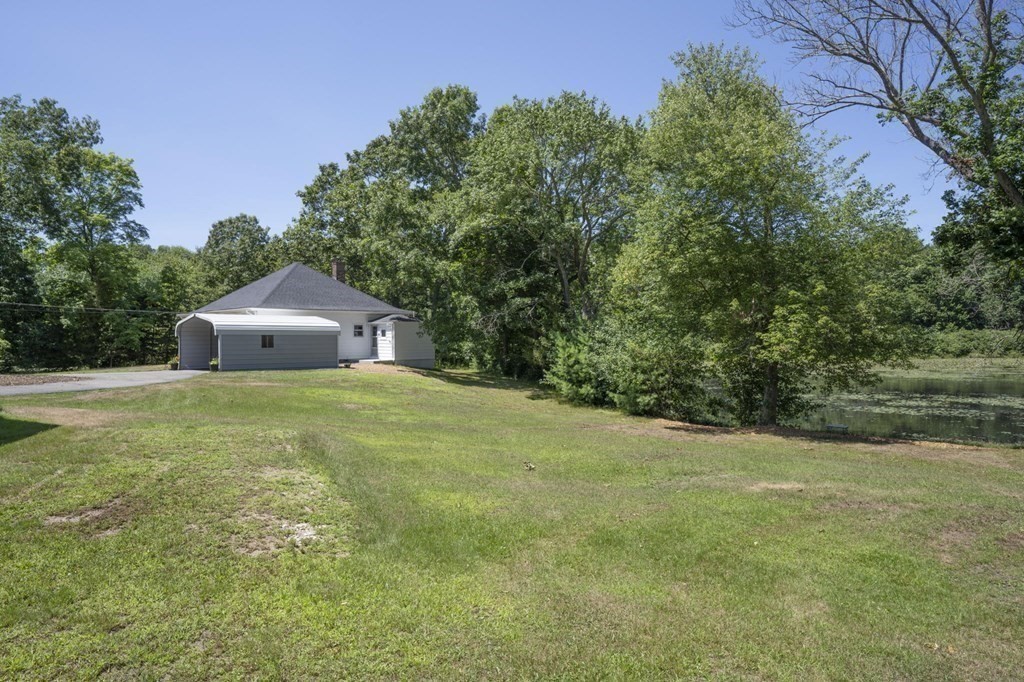 10 R Poquanticut Avenue Easton, MA 02375 - Photo 11 of 38 a front view of a house with a yard