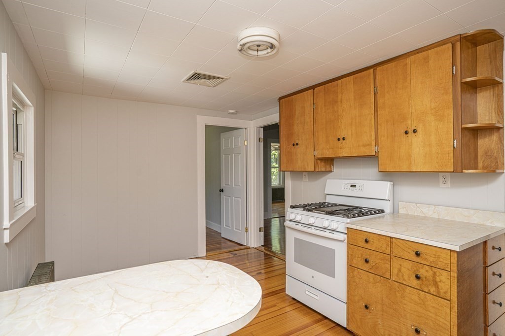 10 R Poquanticut Avenue Easton, MA 02375 - Photo 20 of 38 a kitchen with granite countertop a stove a sink dishwasher and a refrigerator with wooden floor