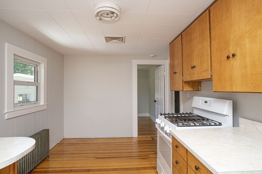 10 R Poquanticut Avenue Easton, MA 02375 - Photo 21 of 38 a kitchen with kitchen island a stove a sink and a refrigerator