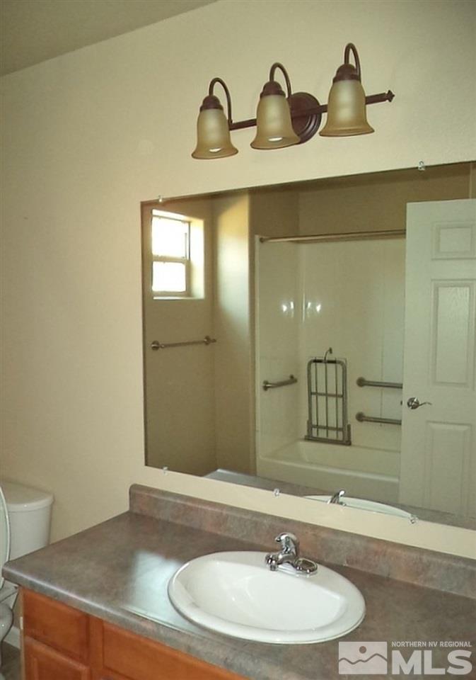 1052 Watt Street Reno, NV 89509 - Photo 15 of 25 a bathroom with a sink and a mirror