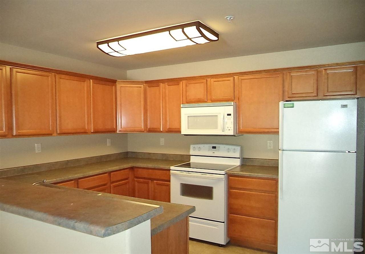 1052 Watt Street Reno, NV 89509 - Photo 16 of 25 a kitchen with a sink a stove a refrigerator and a window