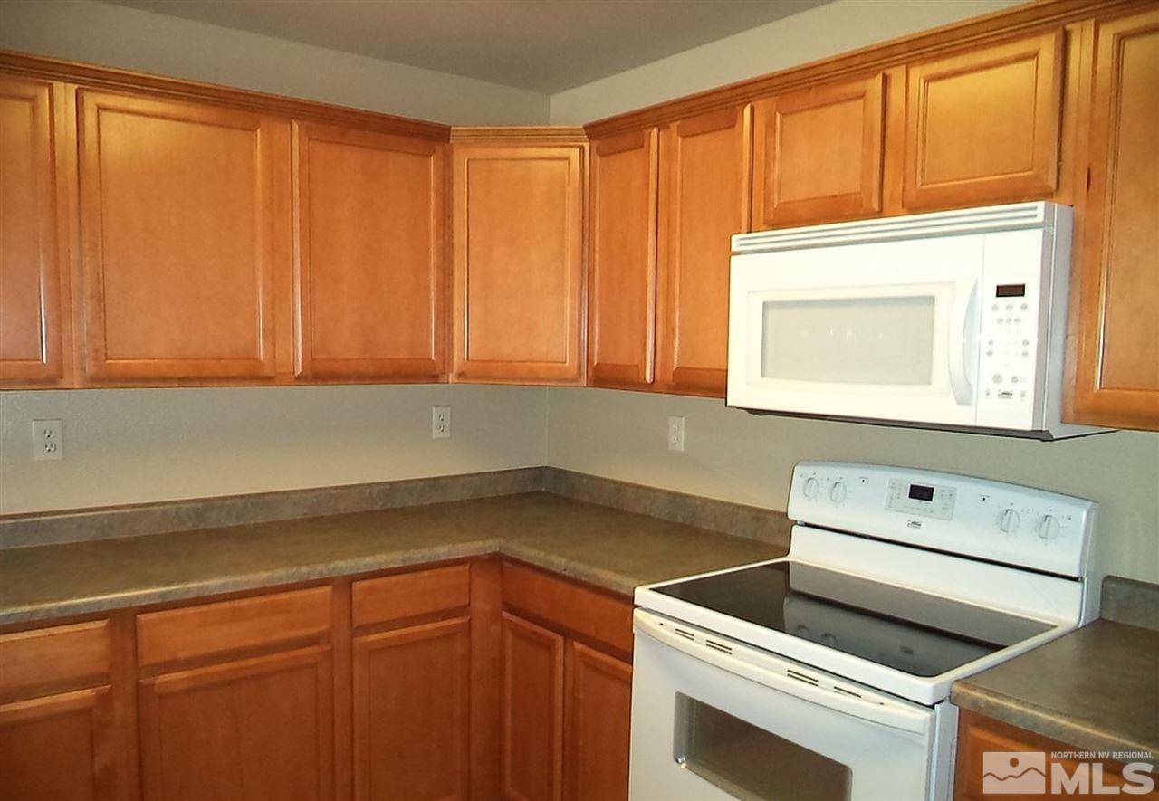 1052 Watt Street Reno, NV 89509 - Photo 6 of 25 a kitchen with a sink cabinets and a microwave oven