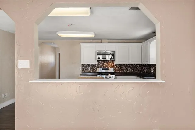 a view of hallway with wooden floor