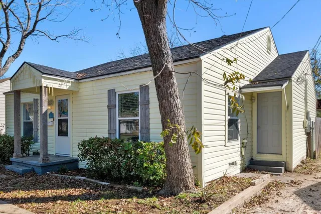a view of a hallway with wooden floor and glass door