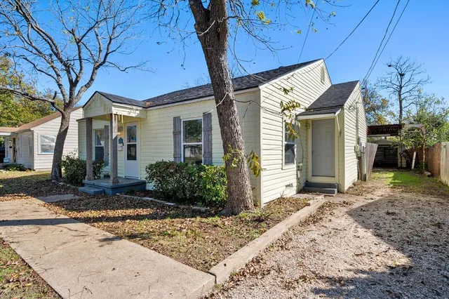 a kitchen with stainless steel appliances granite countertop a refrigerator a sink dishwasher and a stove with wooden floor