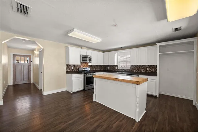 a kitchen with a sink stove top oven and microwave