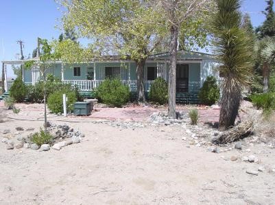 3818 Hollister Road Phelan, CA 92371 - Photo 1 of 1 a view of a house with a yard covered in snow