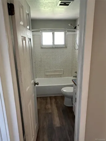 a bathroom with a toilet a sink and shower