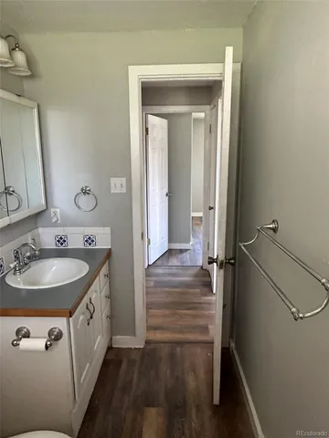 a bathroom with a sink a mirror and a vanity