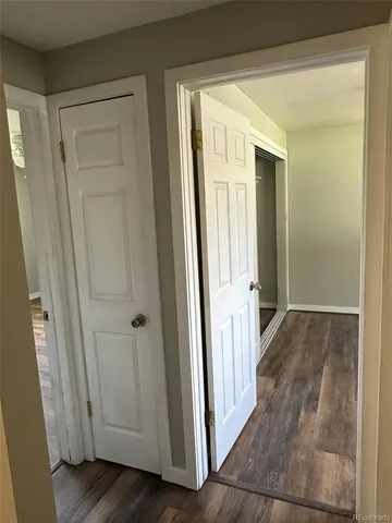 a view of a hallway with wooden floor