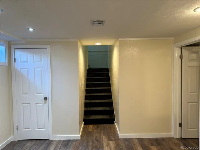 a view of hallway with wooden floor