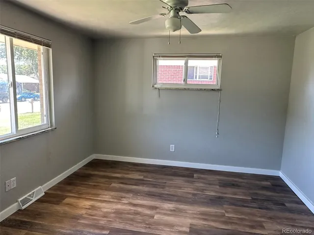 a view of room with window and wooden floor