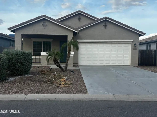 a view of a house with a yard and garage