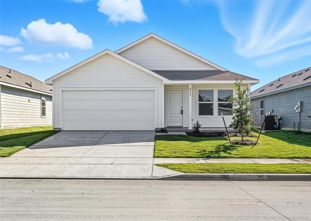 Single story home with driveway, a front lawn, a garage, and a shingled roof