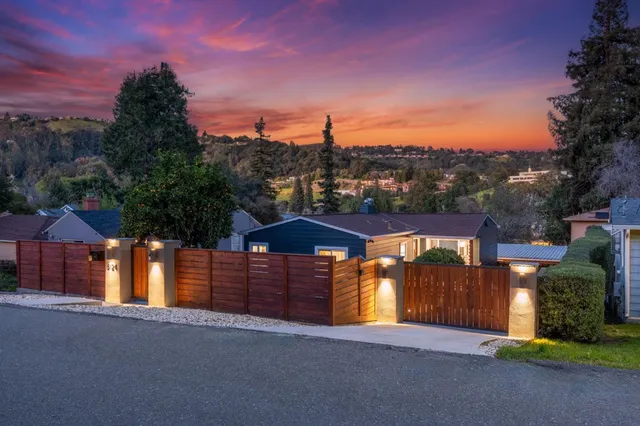 a view of a house with a yard and tree s