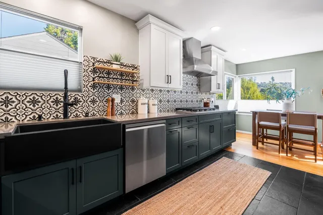 a kitchen with stainless steel appliances kitchen island granite countertop a sink stove and cabinets