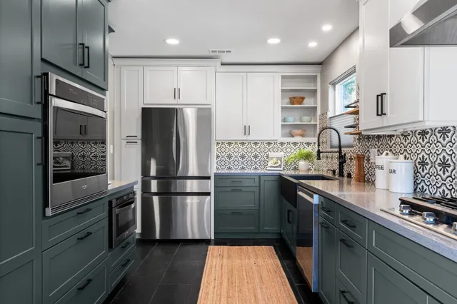 a kitchen with stainless steel appliances a refrigerator sink and microwave