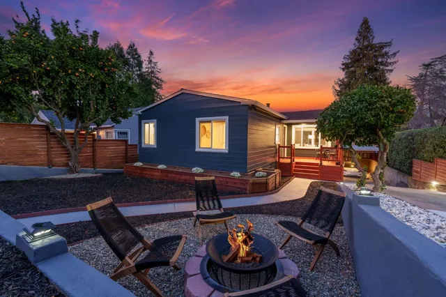 a front view of a house with outdoor seating
