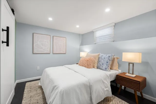 a bedroom with bed and a night stand