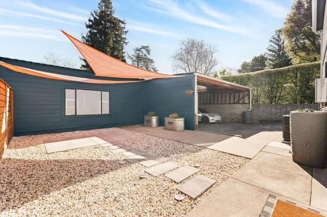 a backyard of a house with basket ball court