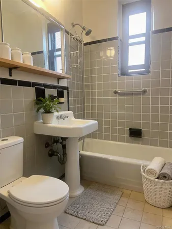 a bathroom with a sink a toilet and bathtub