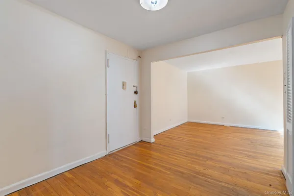 a view of empty room with wooden floor