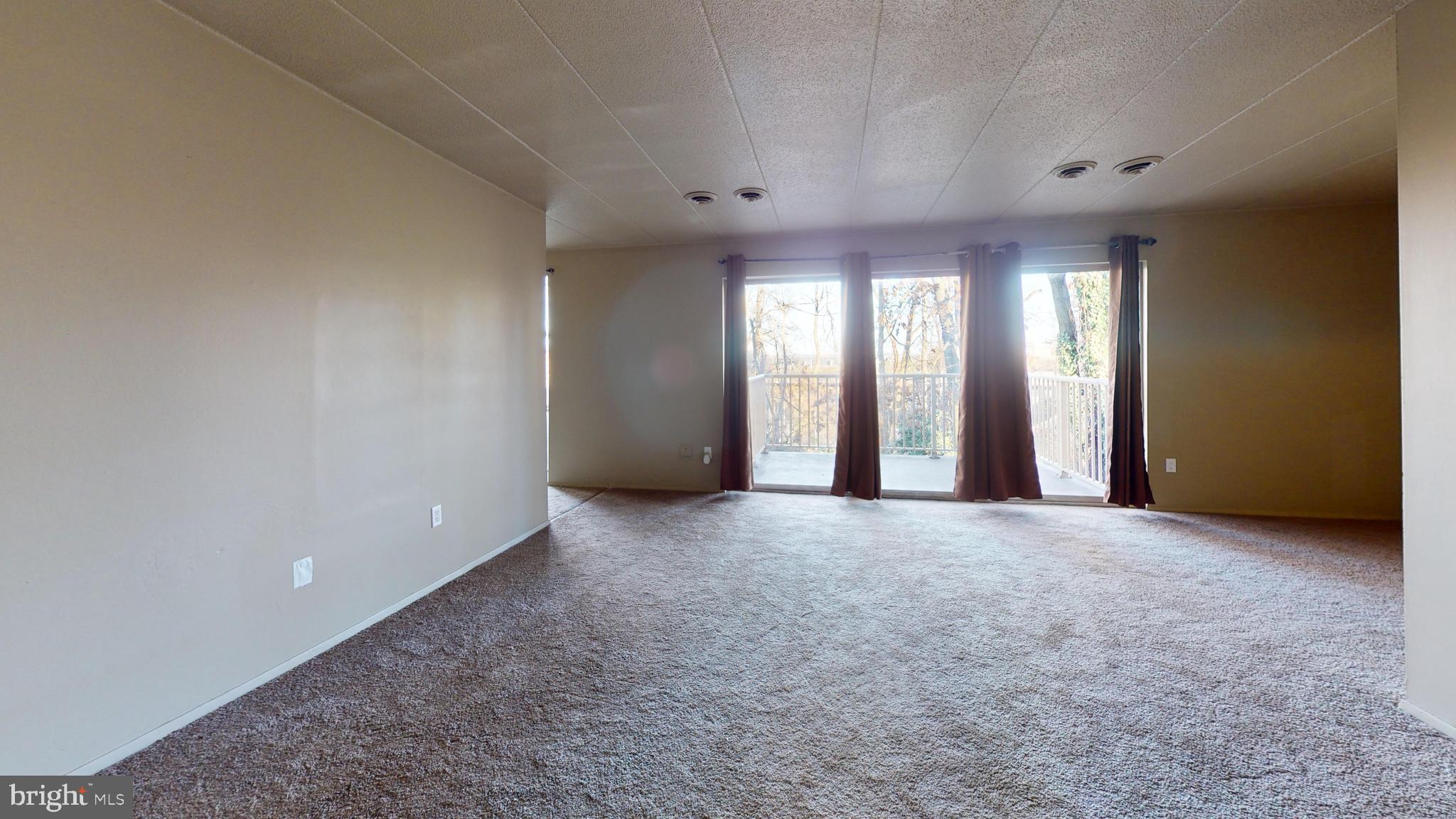 2612 Fort Farnsworth Road, Unit 262 Alexandria, VA 22303 - Photo 22 of 45 a view of an empty room with a fireplace and a window