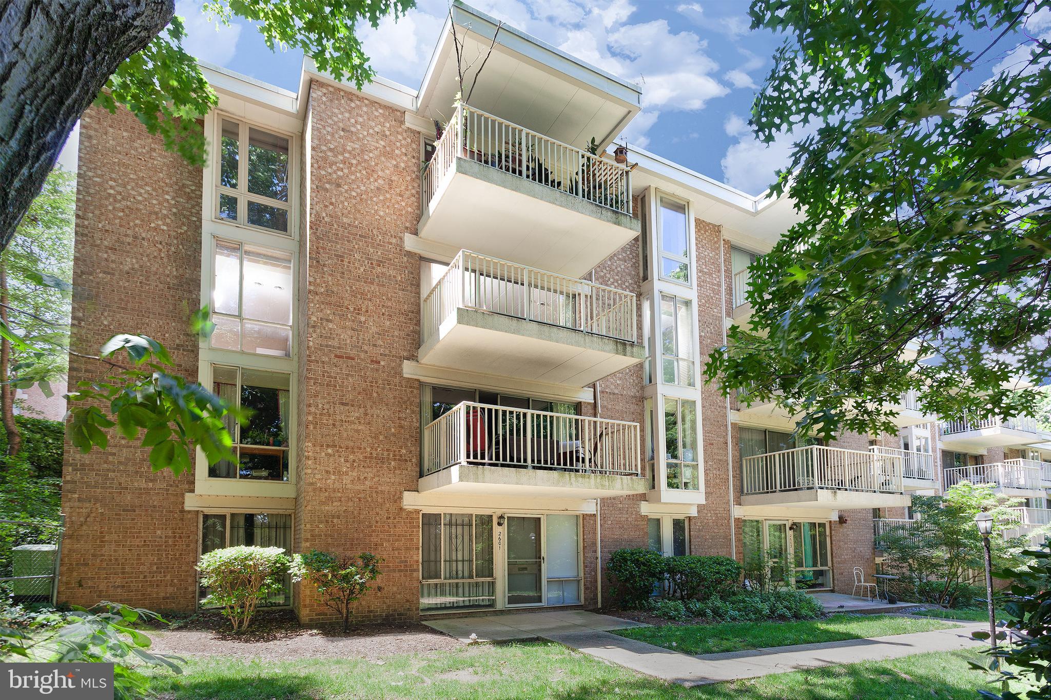 2612 Fort Farnsworth Road, Unit 262 Alexandria, VA 22303 - Photo 27 of 45 front view of a brick house with a yard