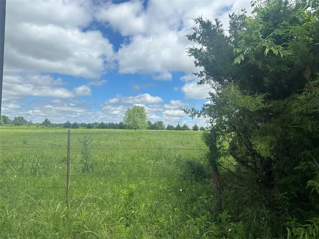 a view of a city with lush green forest