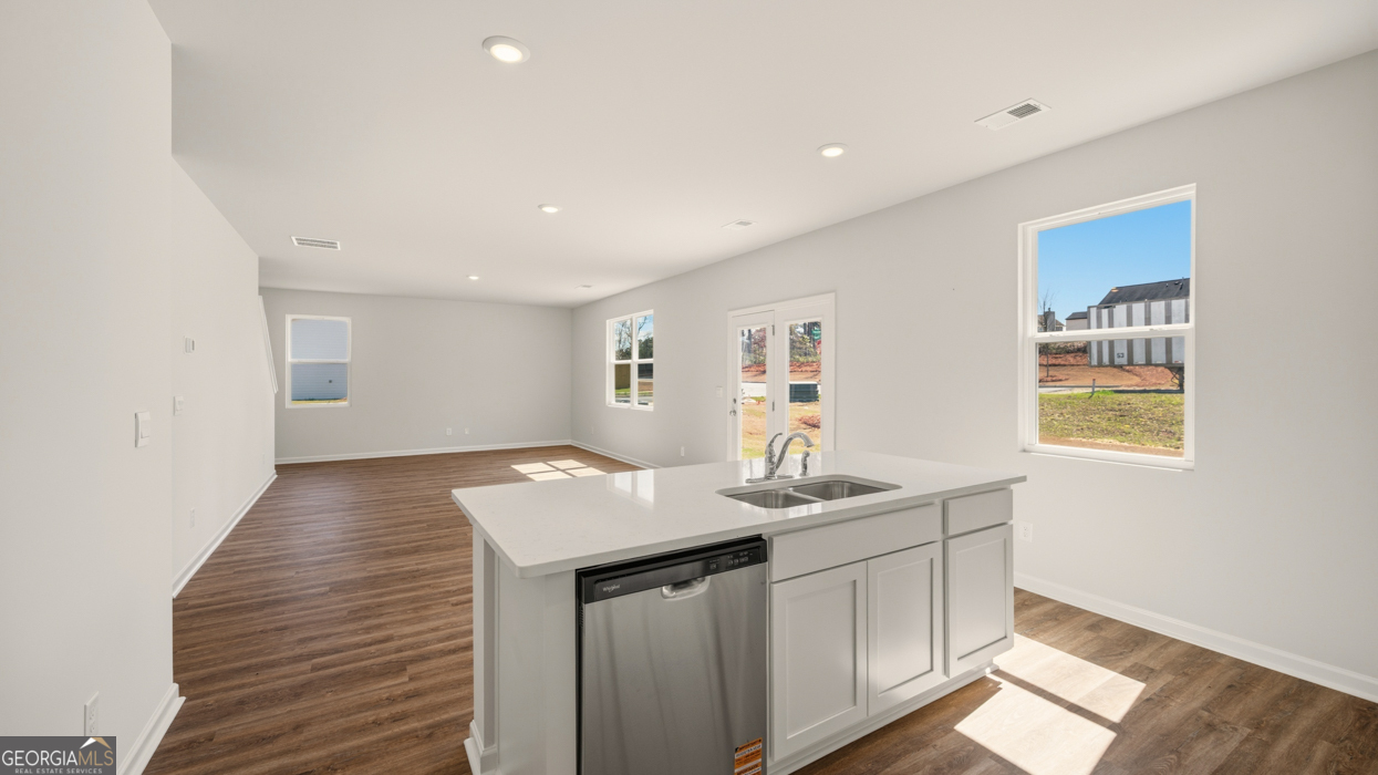 8578 Seabiscuit Road Lithonia, GA 30058 - Photo 12 of 30 a kitchen that has a sink and a table in it