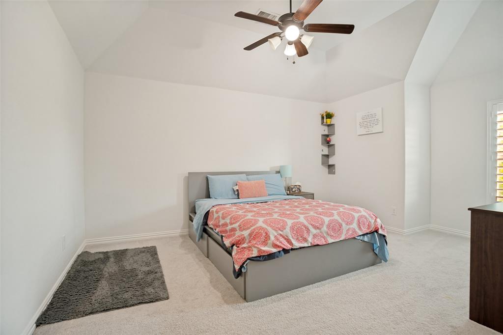 1461 Ramsbury Lane Prosper, TX 75078 - Photo 20 of 30 Bright interior space featuring vaulted ceilings, a ceiling fan with integrated lighting, and carpet flooring